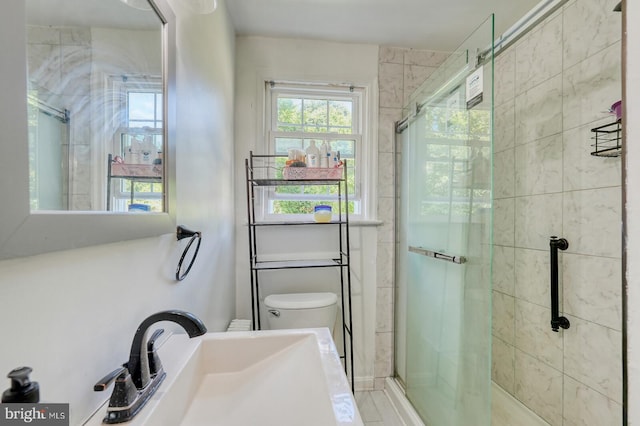 bathroom with vanity, toilet, and a shower with shower door