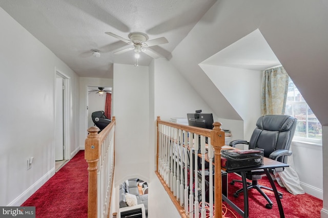 office featuring a textured ceiling, ceiling fan, and carpet