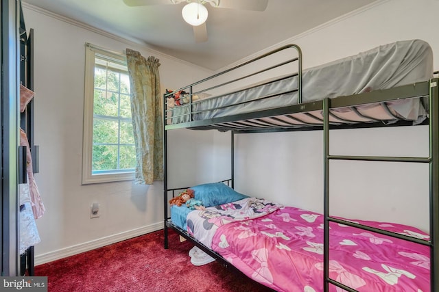 carpeted bedroom with ceiling fan and ornamental molding