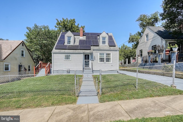 new england style home with a front yard, a deck, and solar panels