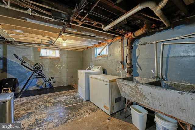 basement with independent washer and dryer, plenty of natural light, fridge, and sink