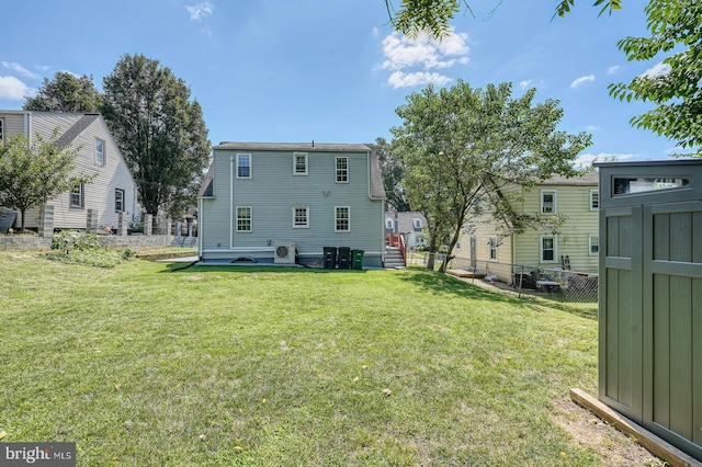 rear view of house featuring a yard