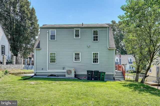 back of property featuring ac unit and a yard