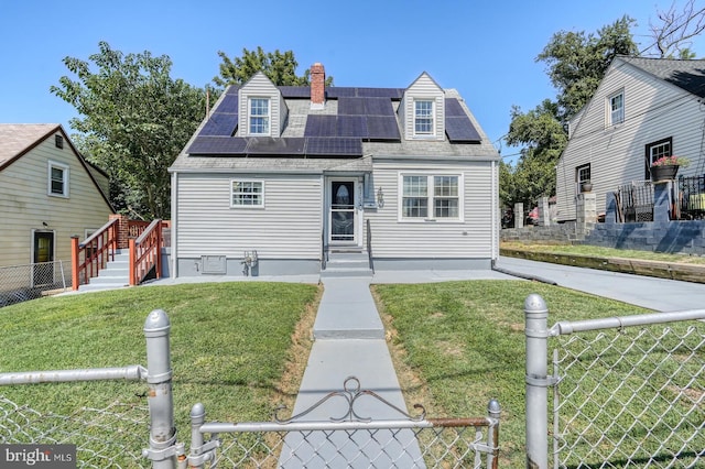 cape cod home with a front yard and solar panels