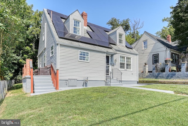 view of front of house with a front lawn and solar panels