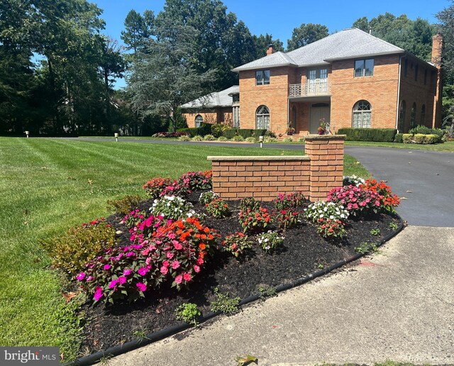 back of property featuring a lawn