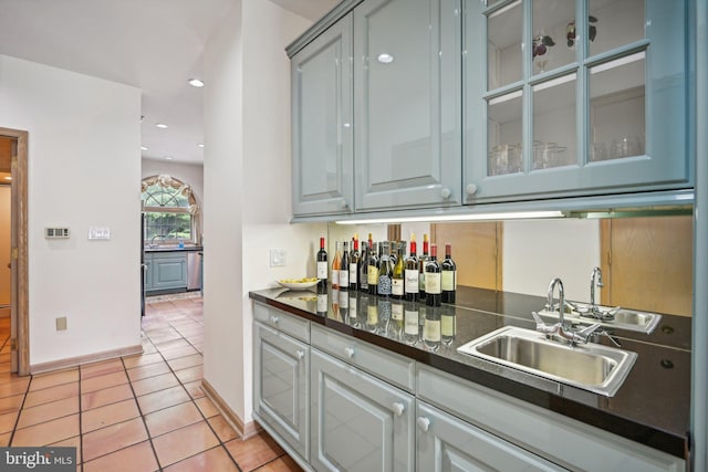 kitchen featuring light tile patterned flooring and sink