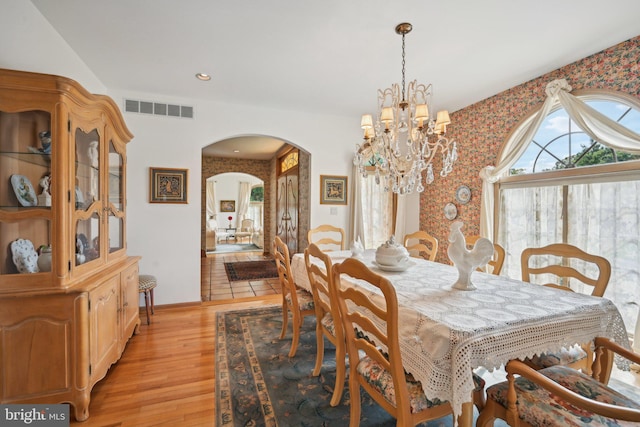 dining room with a notable chandelier and light hardwood / wood-style floors