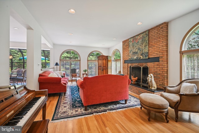 living room featuring wood-type flooring and a fireplace