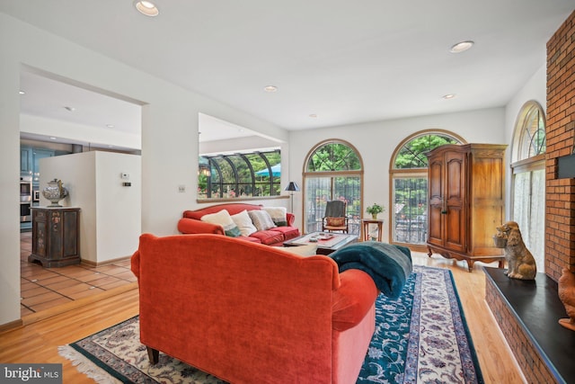 living room featuring light hardwood / wood-style flooring and a fireplace