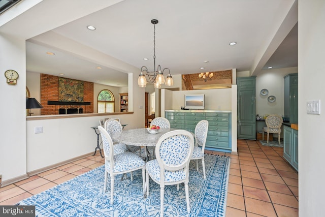 tiled dining space with a chandelier