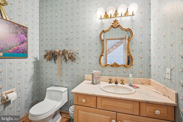 bathroom featuring vanity and toilet