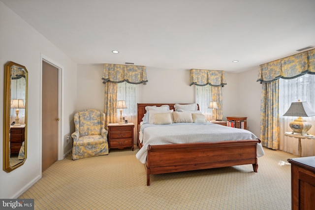 carpeted bedroom with multiple windows