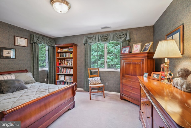 carpeted bedroom with multiple windows