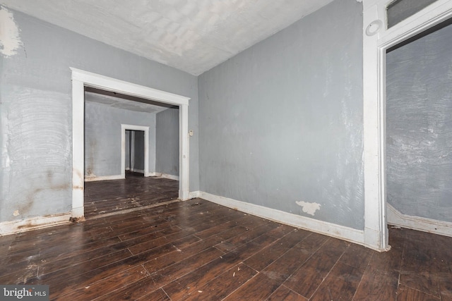 spare room featuring dark wood-type flooring