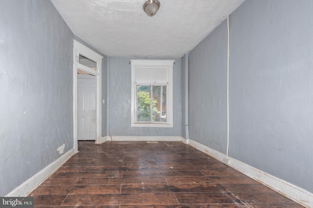 unfurnished bedroom featuring dark hardwood / wood-style floors and a textured ceiling