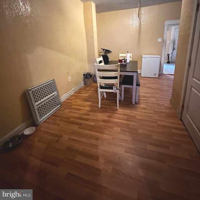 dining room with an inviting chandelier and dark hardwood / wood-style flooring