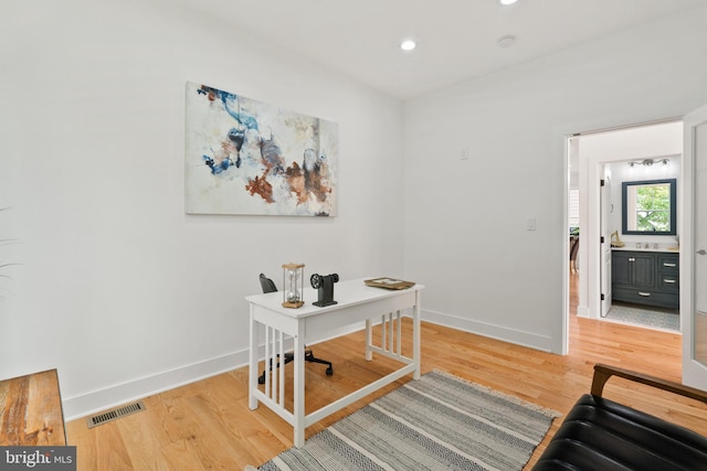 office with hardwood / wood-style flooring