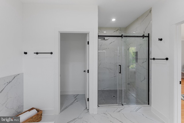 bathroom with a shower with door