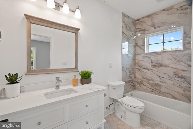 full bathroom with tiled shower / bath, vanity, toilet, and a wealth of natural light