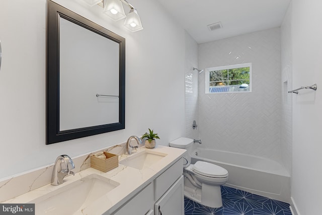 full bathroom with vanity, tiled shower / bath combo, toilet, and tile patterned flooring