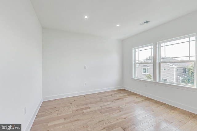 unfurnished room with light wood-type flooring