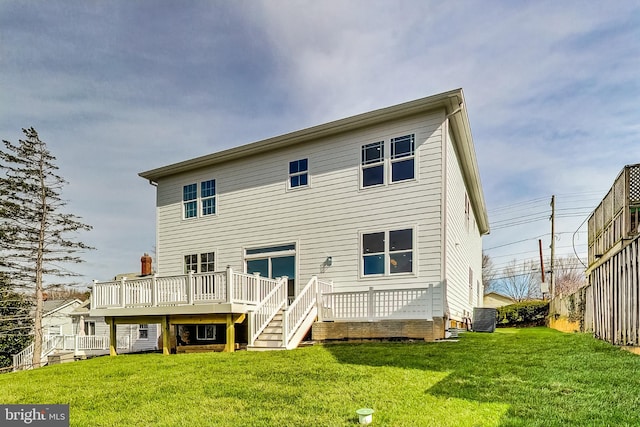 rear view of property with a yard, a deck, and central air condition unit