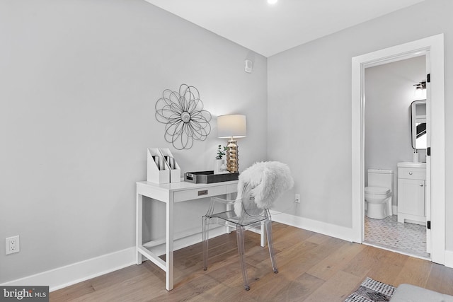 home office with hardwood / wood-style flooring