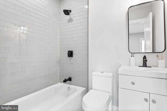 full bathroom featuring toilet, tiled shower / bath combo, and vanity