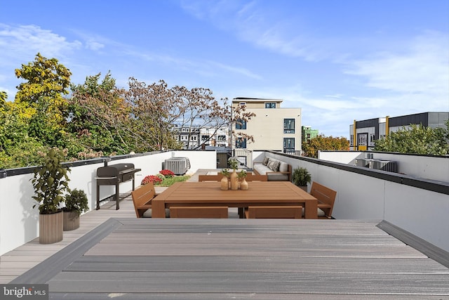 wooden deck featuring an outdoor living space and area for grilling