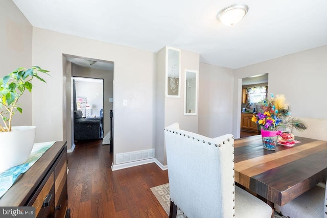 dining room with dark hardwood / wood-style flooring