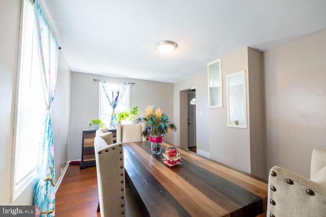 dining room with dark hardwood / wood-style flooring