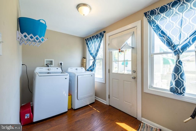 clothes washing area with dark hardwood / wood-style floors and independent washer and dryer