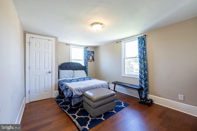 bedroom with dark hardwood / wood-style flooring