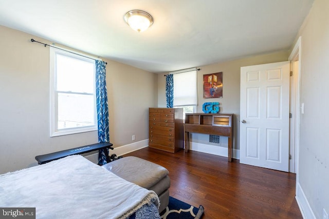 bedroom with dark hardwood / wood-style floors