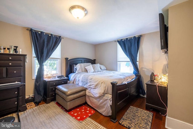 bedroom with dark hardwood / wood-style flooring