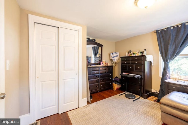 bedroom featuring dark hardwood / wood-style flooring and a closet