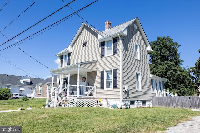 view of front of house with a front yard and a porch