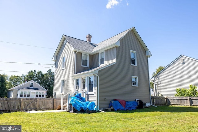 back of property featuring a lawn