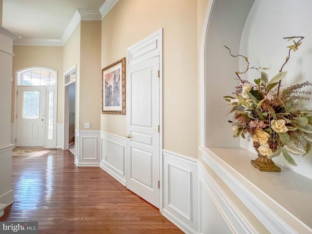 interior space with hardwood / wood-style floors and ornamental molding