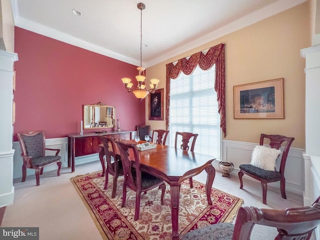 carpeted dining area featuring crown molding and a chandelier