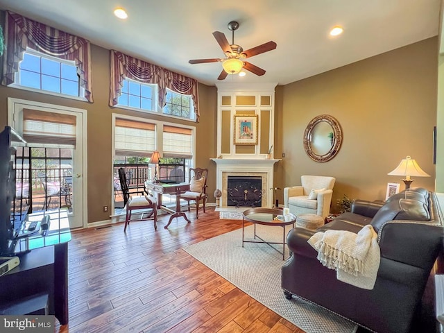 living room with hardwood / wood-style floors, plenty of natural light, and ceiling fan