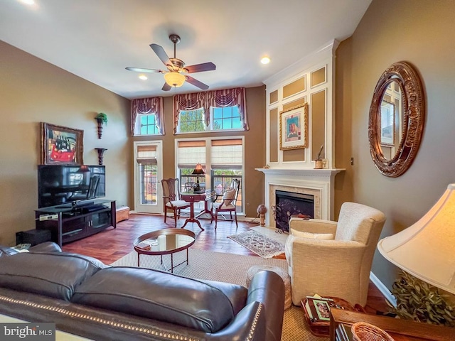 living room with wood-type flooring and ceiling fan