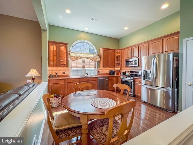 kitchen featuring backsplash, dark wood-type flooring, sink, and stainless steel appliances