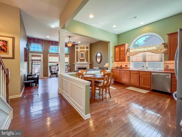 kitchen with dishwasher, wood-type flooring, ceiling fan, and a healthy amount of sunlight