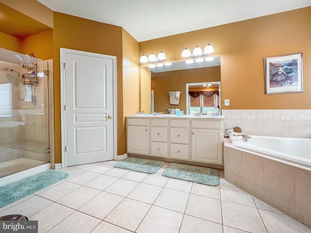 bathroom featuring tile patterned flooring, shower with separate bathtub, and vanity