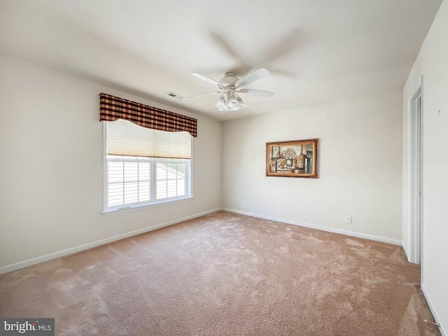 carpeted empty room featuring ceiling fan