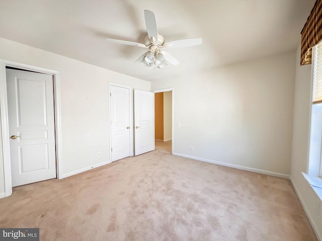 unfurnished bedroom featuring ceiling fan and light carpet