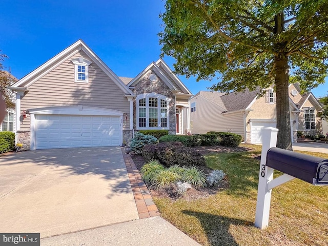 front of property featuring a garage and a front lawn