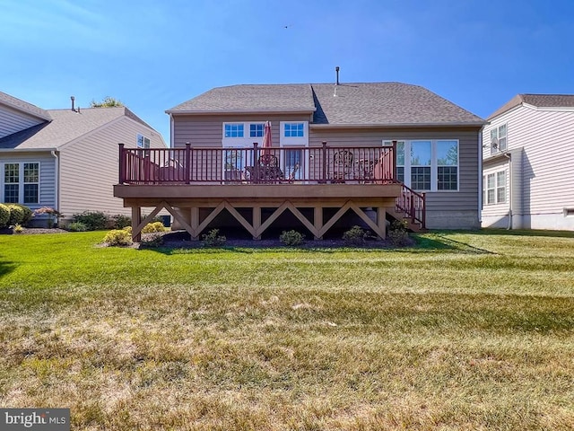 back of house featuring a yard and a wooden deck